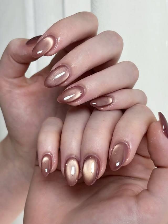 14. Soft Rose Gold Cat-Eye Almond Nails - rose gold nail ideas