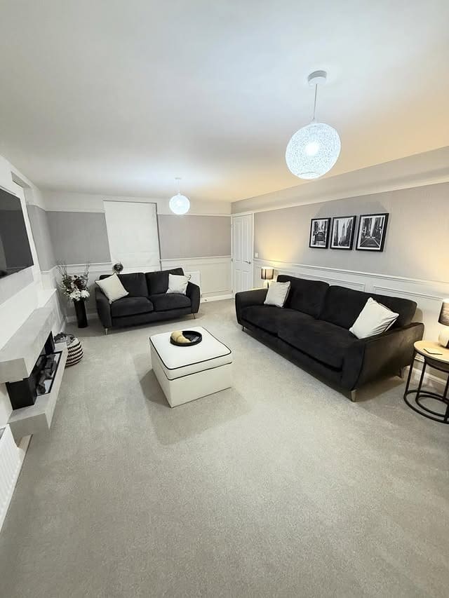 11. Black Sofas and Pale Grey Living Room Idea - black and grey living room ideas