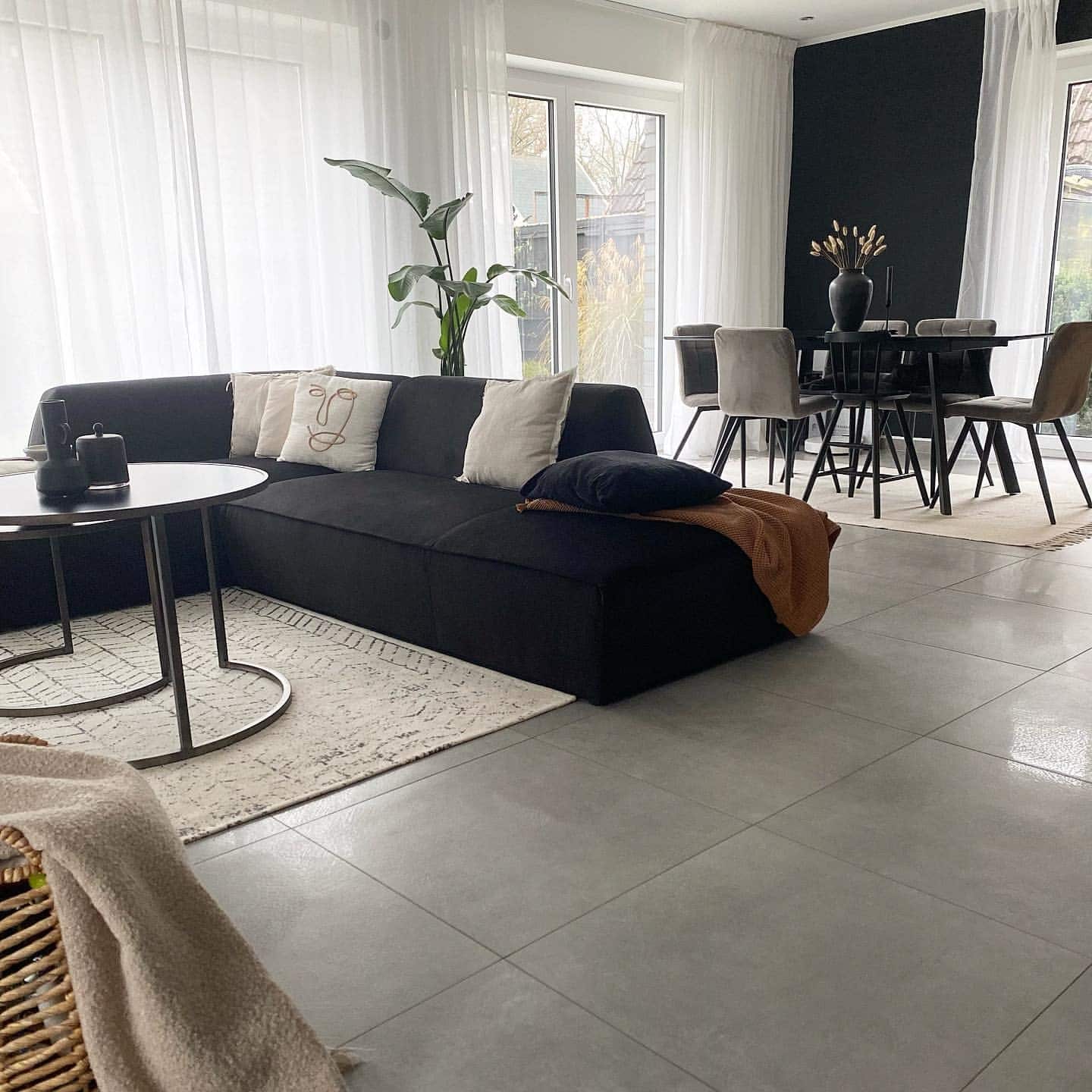 13. Black Sectional and Soft Grey Open Living Room Idea - black and grey living room ideas