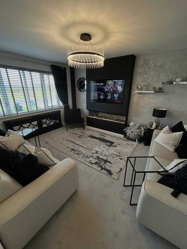 18. Black Fireplace Wall and Cream Grey Living Room Idea - black and grey living room ideas