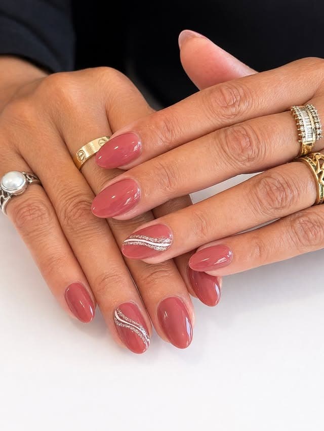 2. Dusty Rose Round Nails with Crystal Waves - round nail ideas
