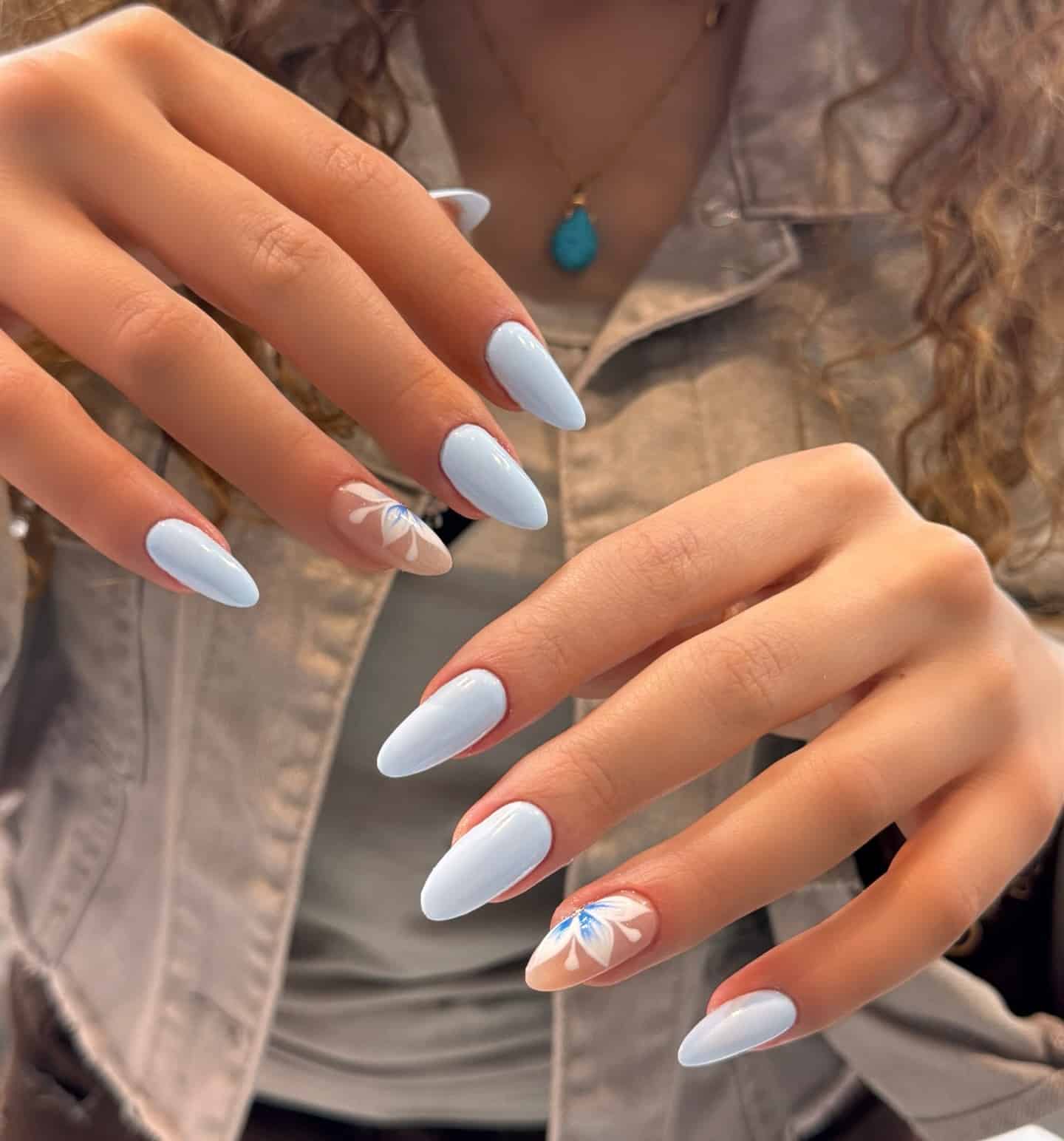 10. Baby Blue Floral Accent Almond Nails - baby blue nail ideas