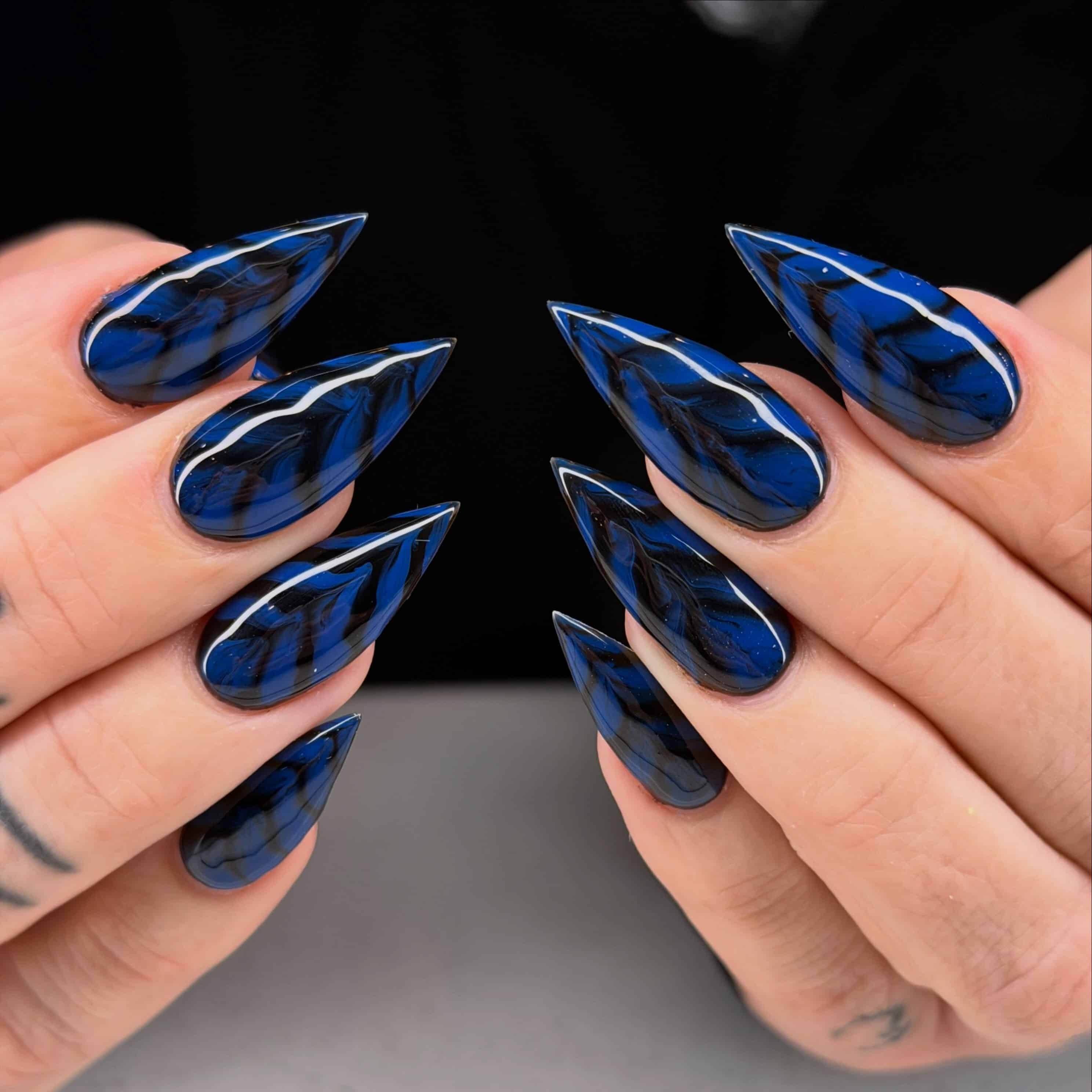 3. Black and Cobalt Blue Marble Stiletto Nails - black and blue nail ideas