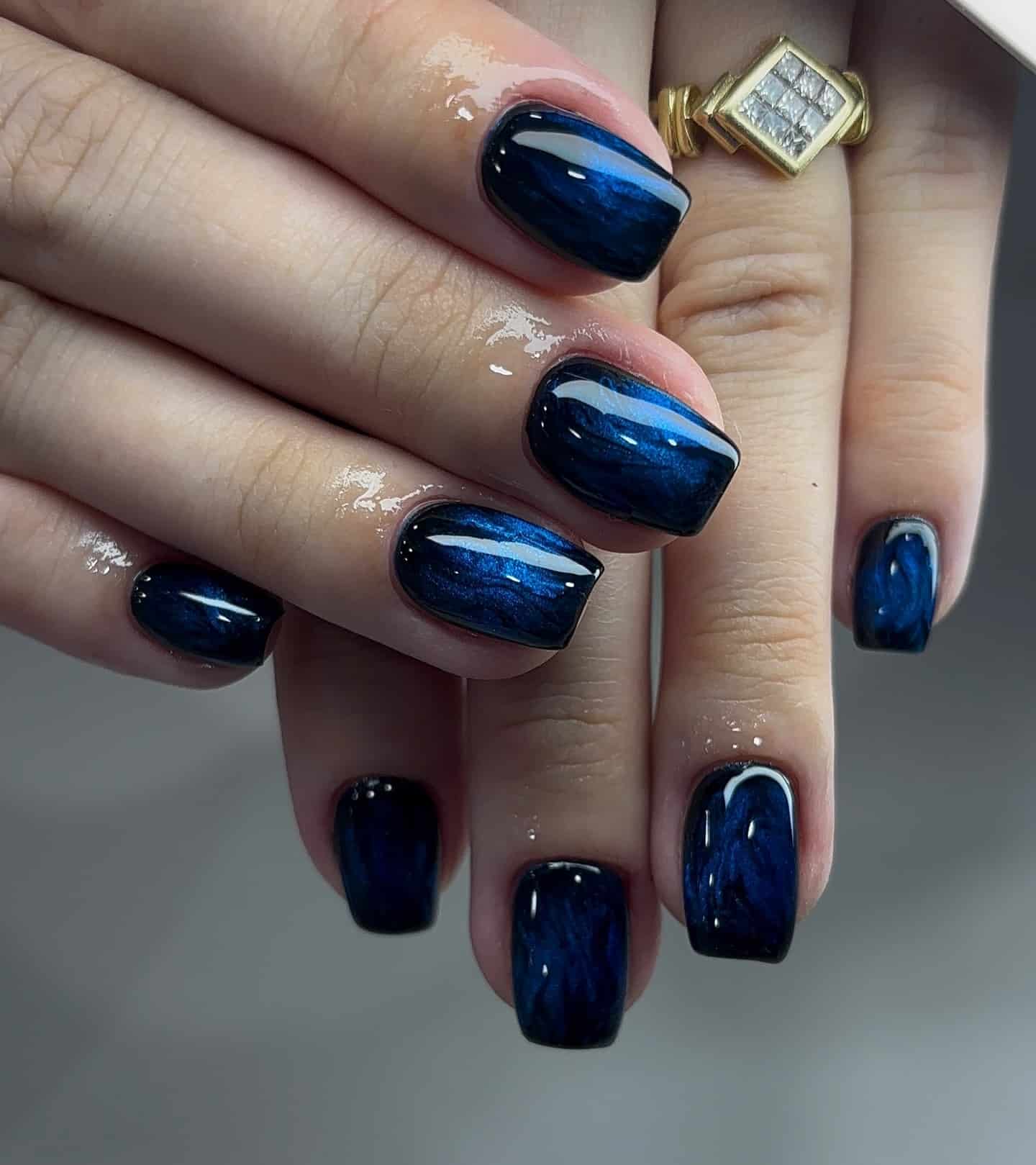 11. Midnight Blue Cat-Eye Short Square Nails - black and blue nail ideas