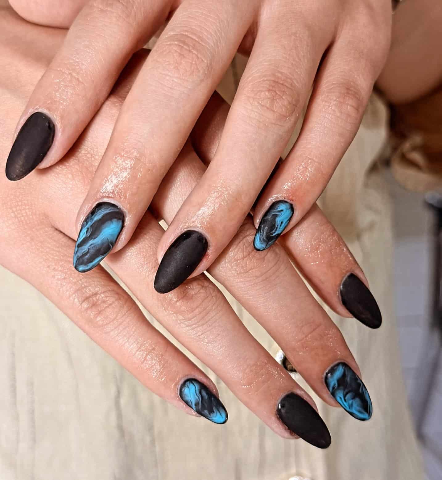 14. Matte Black and Turquoise Blue Marble Almond Nails - black and blue nail ideas