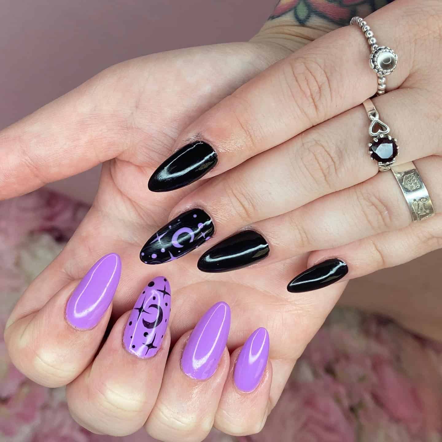 6. Black and Lilac Almond Nails with Celestial Art - black and purple nail ideas
