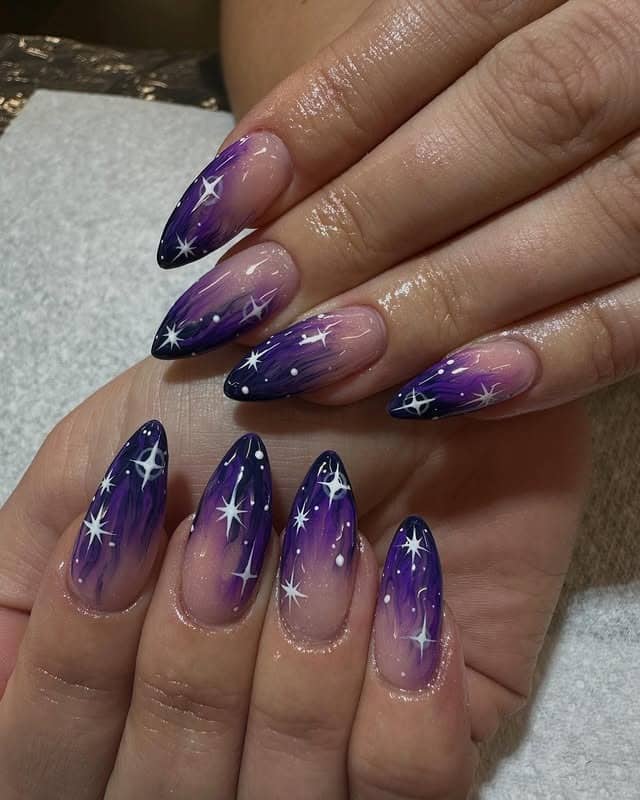 13. Purple Galaxy Almond Nails with Black Tips - black and purple nail ideas