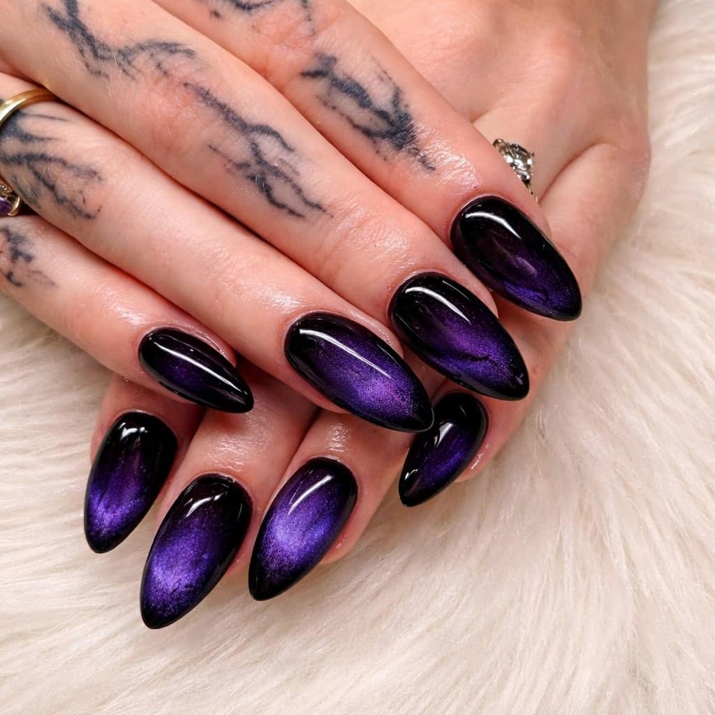 19. Black and Metallic Purple Cat-Eye Almond Nails - black and purple nail ideas
