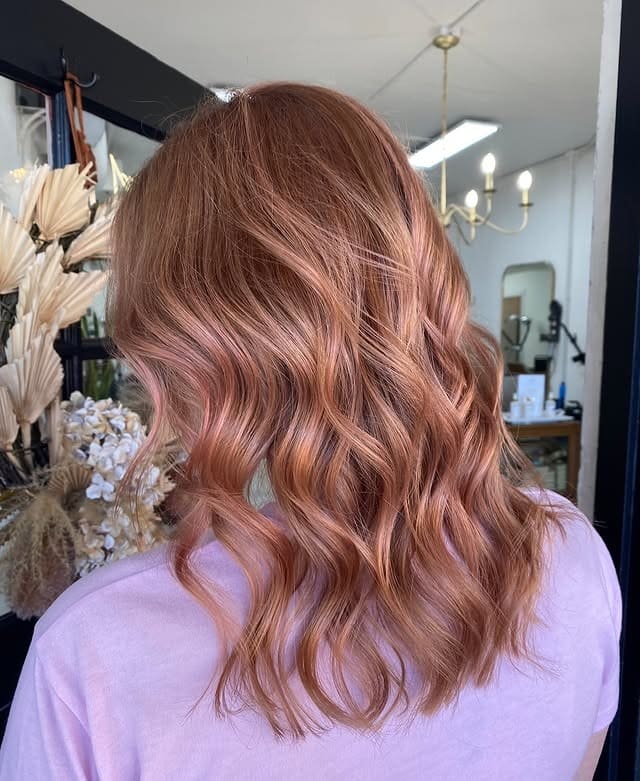9. Burnished Rose Gold Wavy Lob - Rose Gold Hair Color