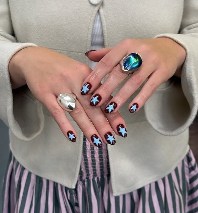 2. Burgundy and Blue Star Short Nails - star nail ideas