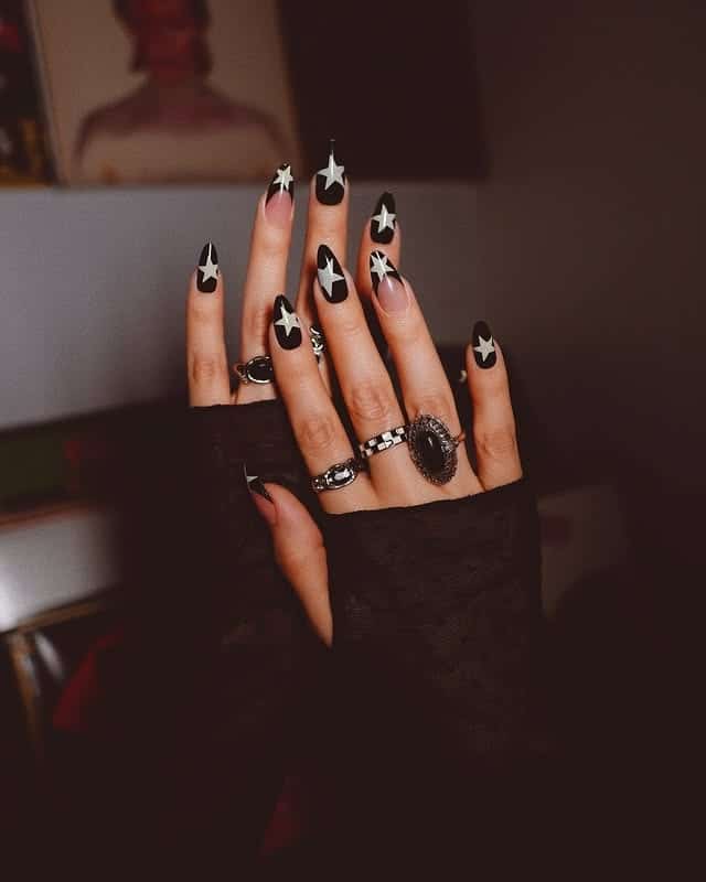 4. Black and Silver Star Stiletto Nails - star nail ideas
