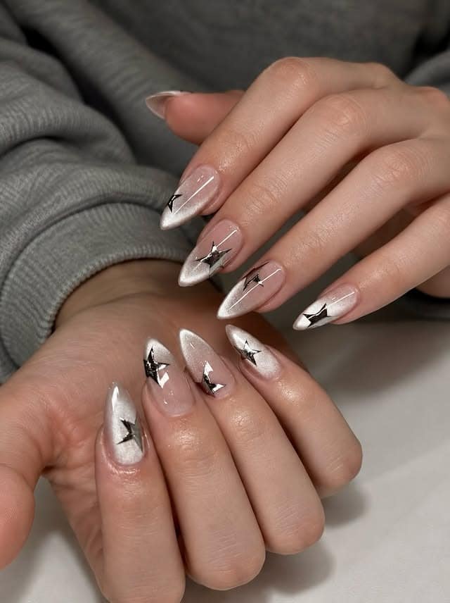 6. Pearl White and Black Metallic Star Almond Nails - star nail ideas
