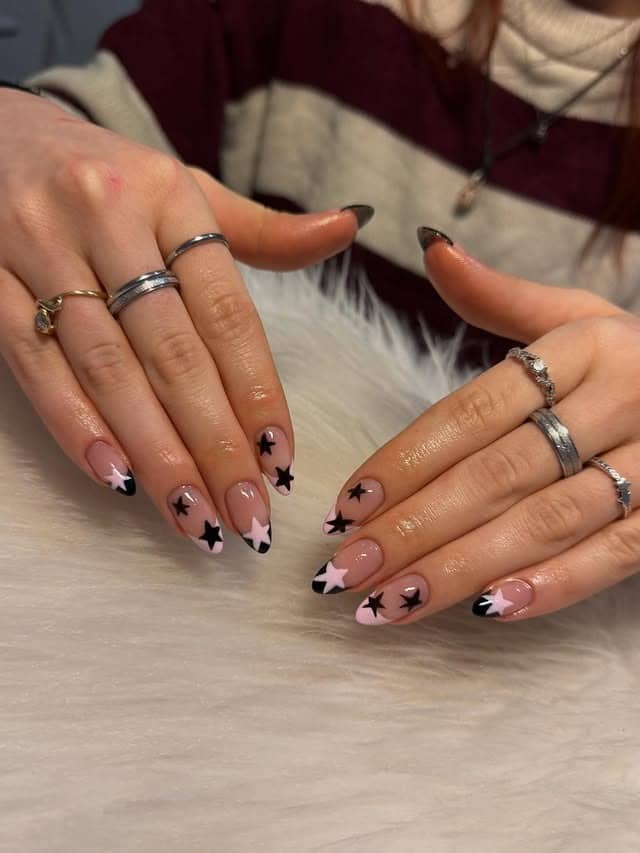 14. Pink and Black Star French Almond Nails - star nail ideas