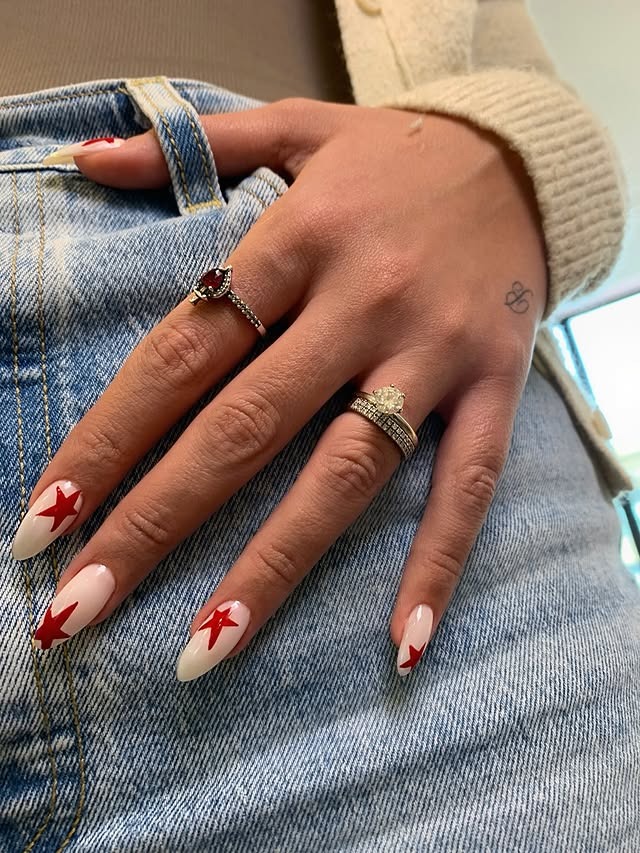 20. Milky White and Red Star Almond Nails - star nail ideas