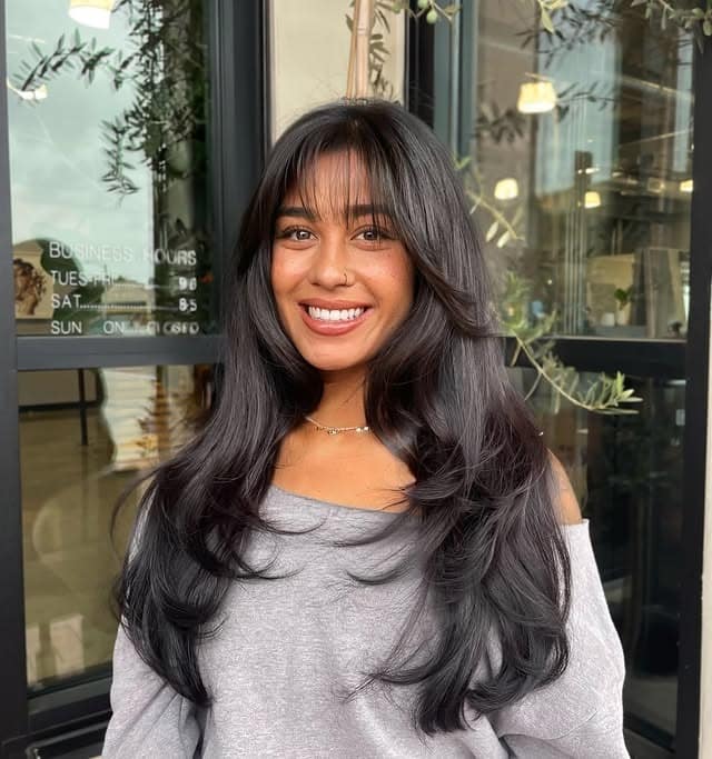 6. Soft Black Butterfly Haircut with Wispy Bangs - Face-Framing Haircuts