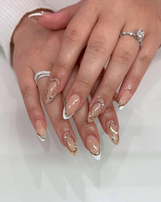 5. Nude Pink Almond Nails with Gold Chrome Swirls - aesthetic nail ideas