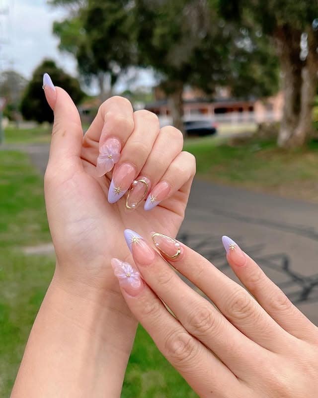 7. Lavender French Tip Nails with 3D Floral and Gold Star Details - aesthetic nail ideas