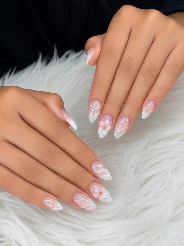 9. Sheer Pink Almond Nails with White Swirls and 3D Flowers - aesthetic nail ideas