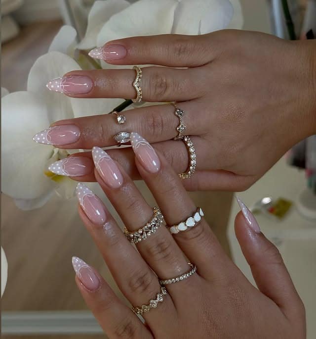 15. Sheer Pink Almond Nails with White Polka Dot French Tips - aesthetic nail ideas