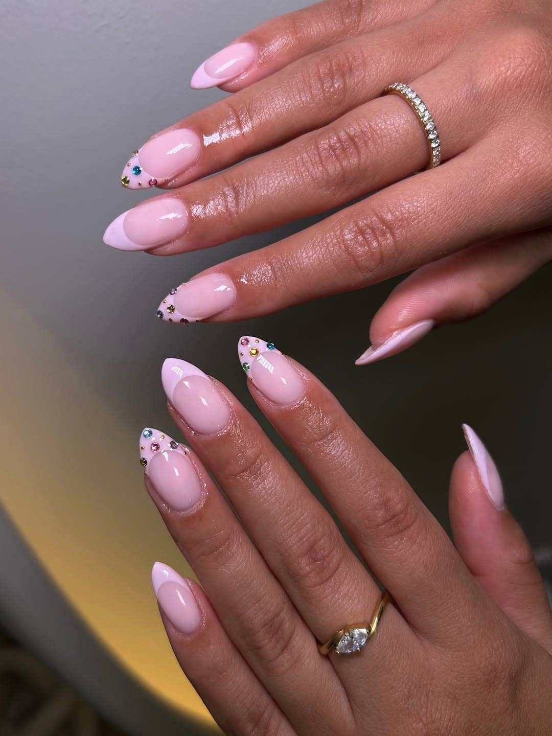 16. Pastel Pink French Tip Nails with Colorful Rhinestones - aesthetic nail ideas