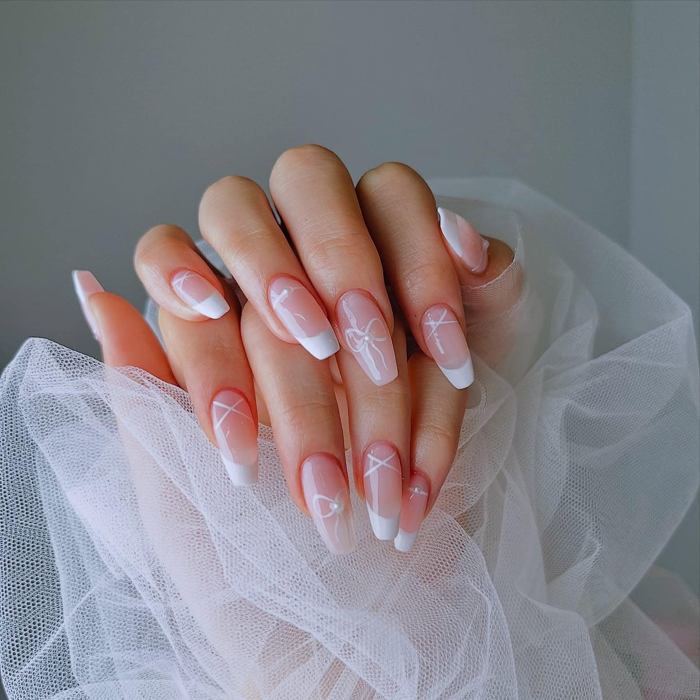 8. Pink and White French Ballerina Nails with Bow Art - ballerina nail ideas
