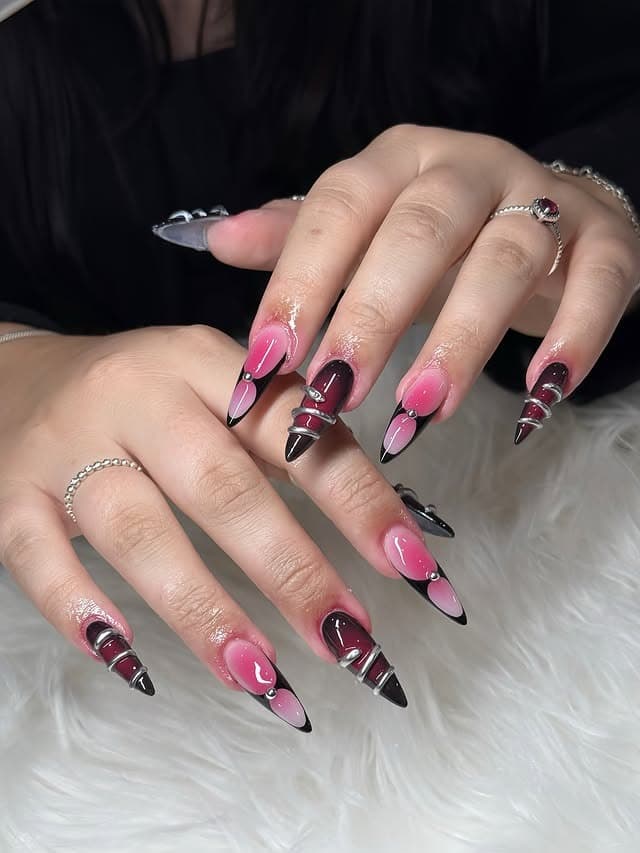 4. Edgy Pink and Black Stiletto Nails with Silver Accents - black and pink nail ideas