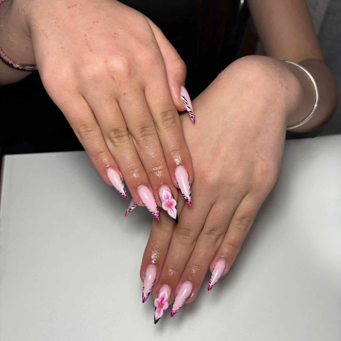 6. Soft Pink and Black Floral Stiletto Nails - black and pink nail ideas