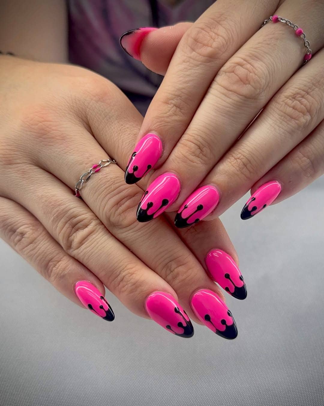 10. Neon Pink and Black Dripping Almond Nails - black and pink nail ideas