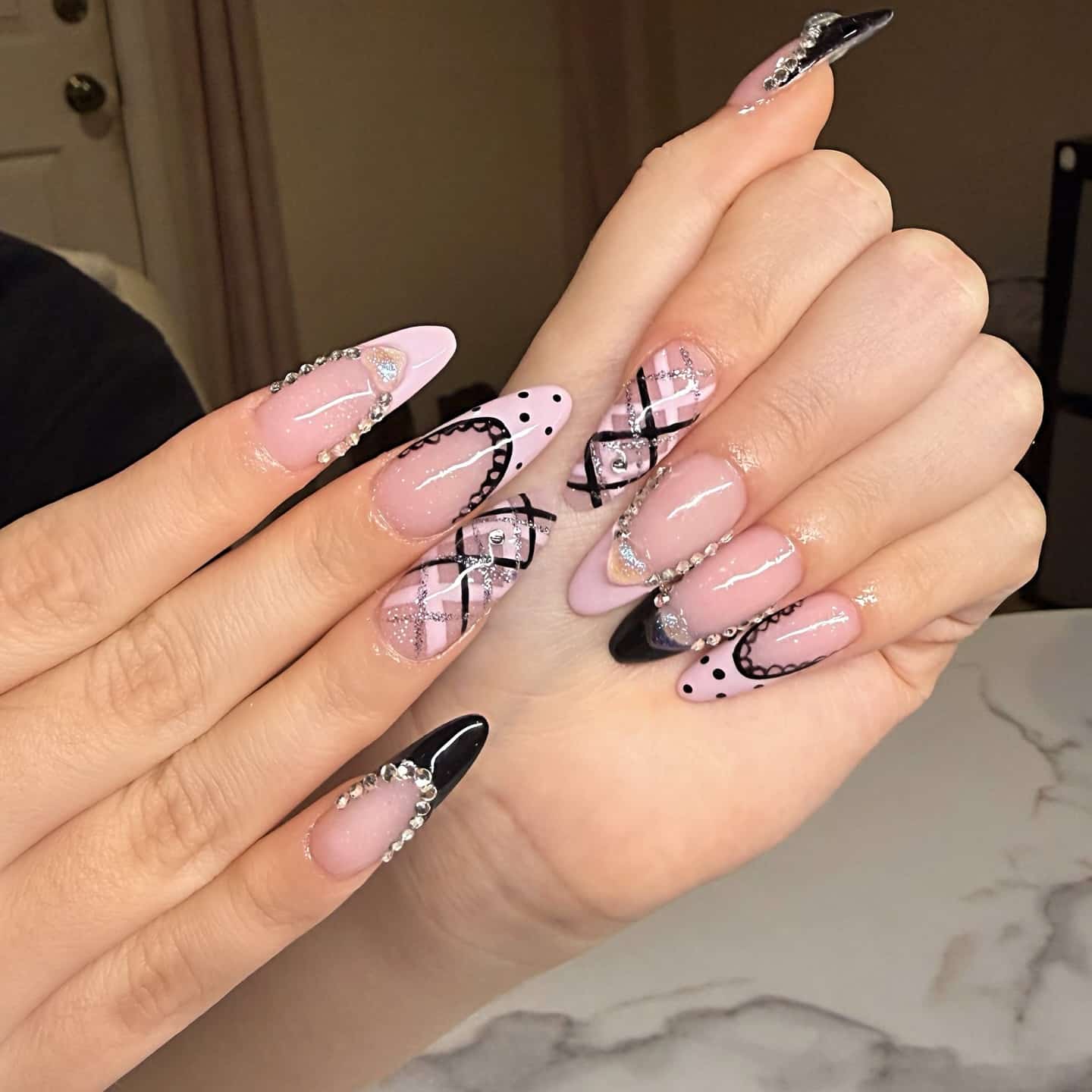 16. Blush Pink and Black Rhinestone Stiletto Nails - black and pink nail ideas