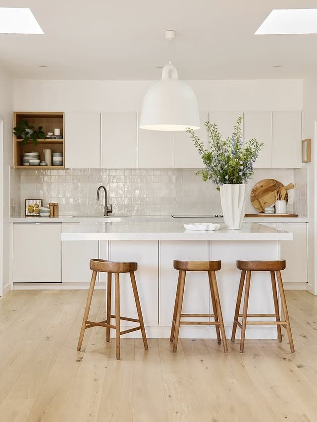 19. Minimalist White Kitchen with Honey Oak Accents - kitchen color ideas with white cabinets