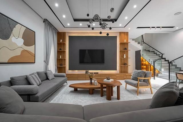 9. Modern Gray and Brown Living Room with Wood Entertainment Wall - gray and brown living room ideas