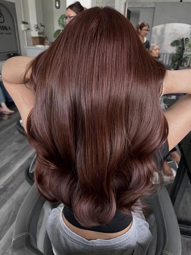 1. Glossy Deep Mahogany Hair with Voluminous Layered Curls - Mahogany Hair Color