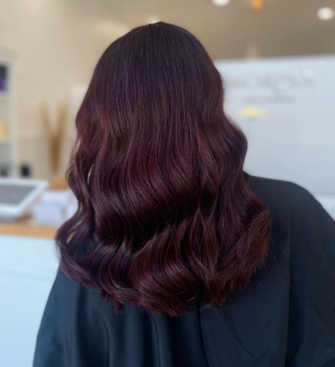 12. Deep Plum Mahogany Hair with Soft Shoulder-Length Waves - Mahogany Hair Color