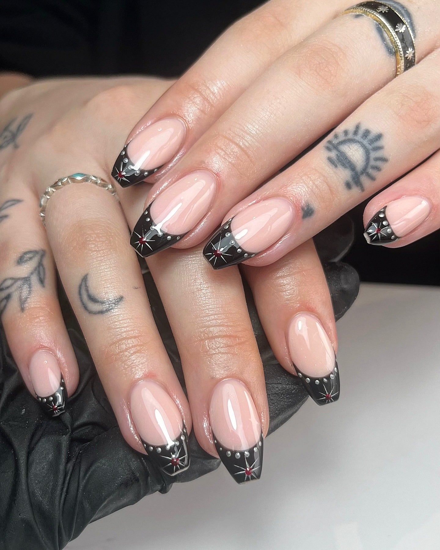 8. Black French Tip Coffin Nails with Silver Studs and Starbursts - black coffin nail ideas
