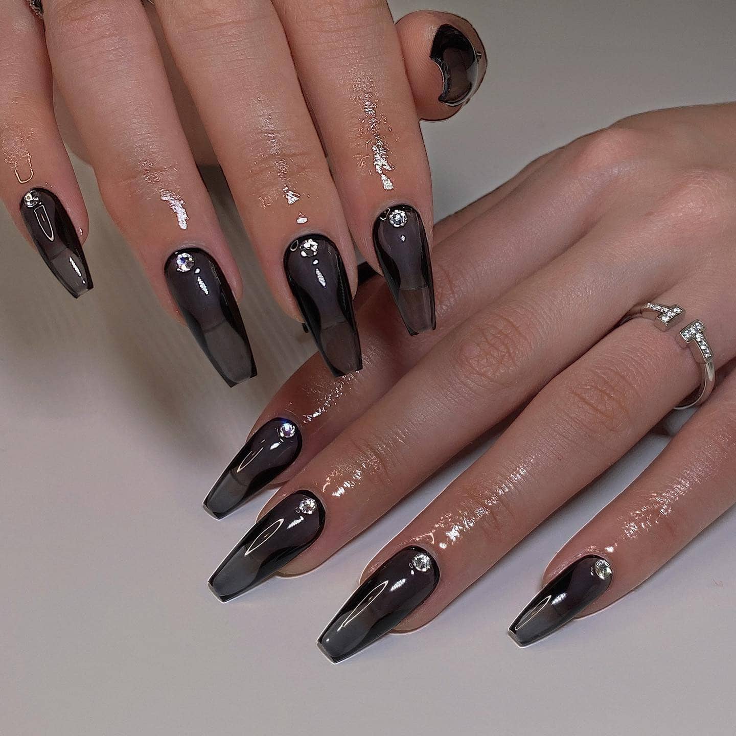 9. Smoky Black Ombre Coffin Nails with Rhinestone Accents - black coffin nail ideas