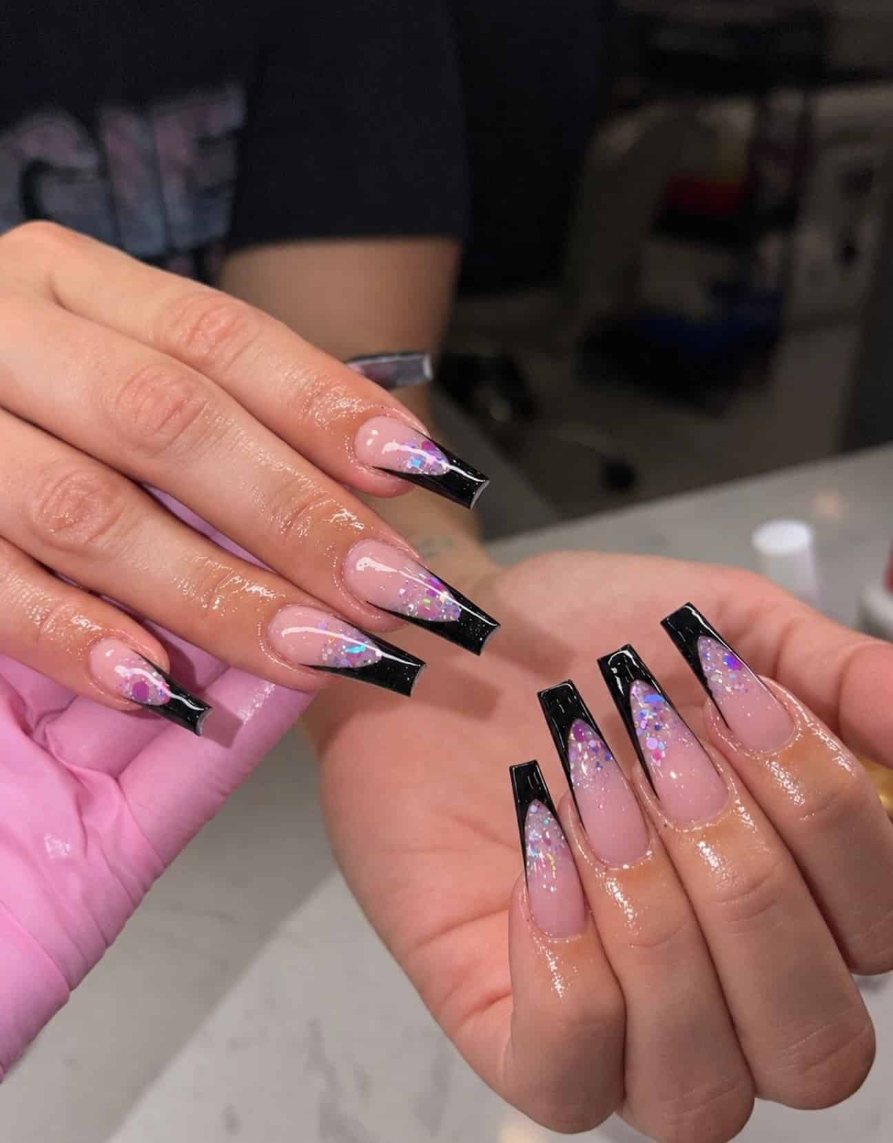 10. Black French Tip Coffin Nails with Iridescent Glitter - black coffin nail ideas