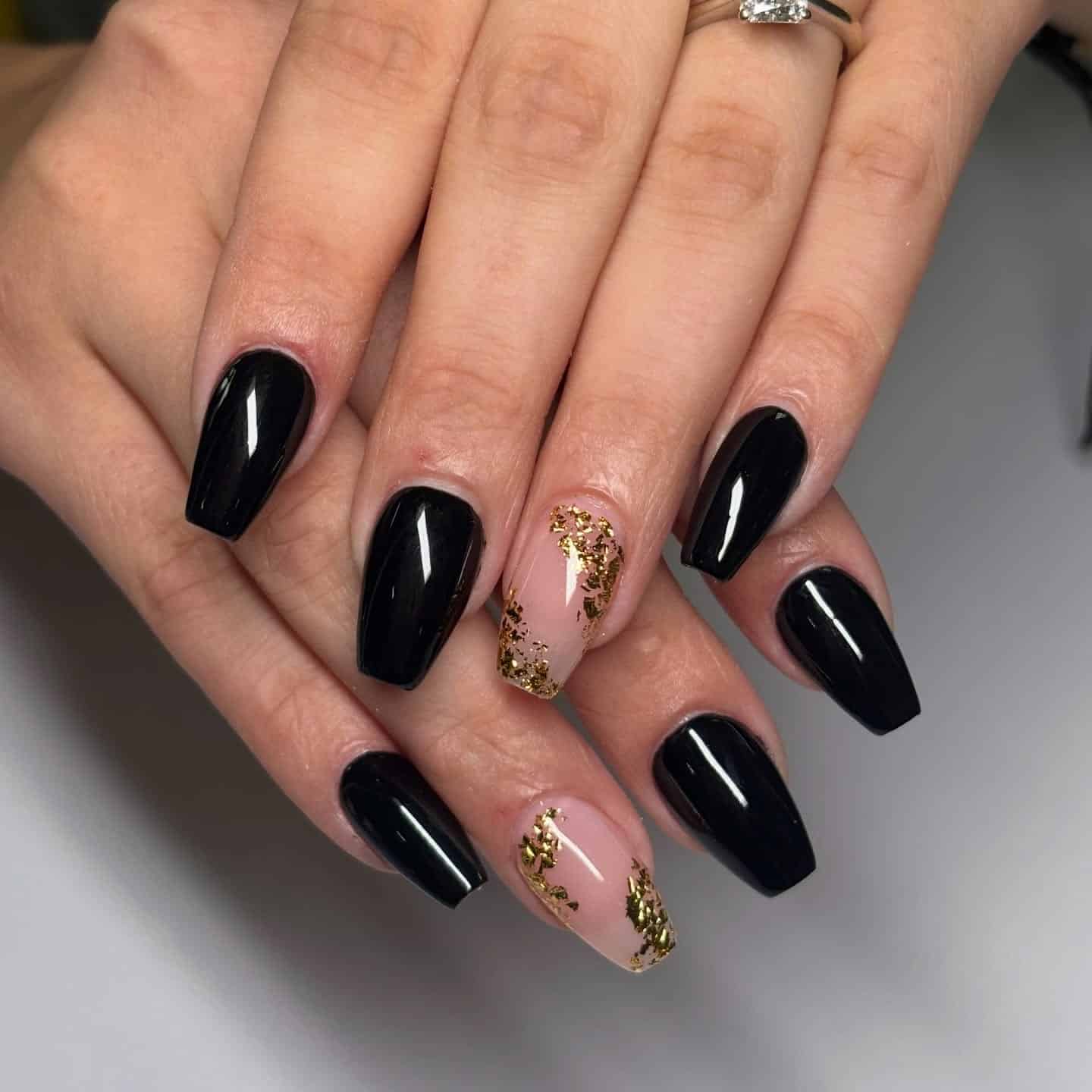 13. Glossy Black Coffin Nails with Gold Foil Accents - black coffin nail ideas