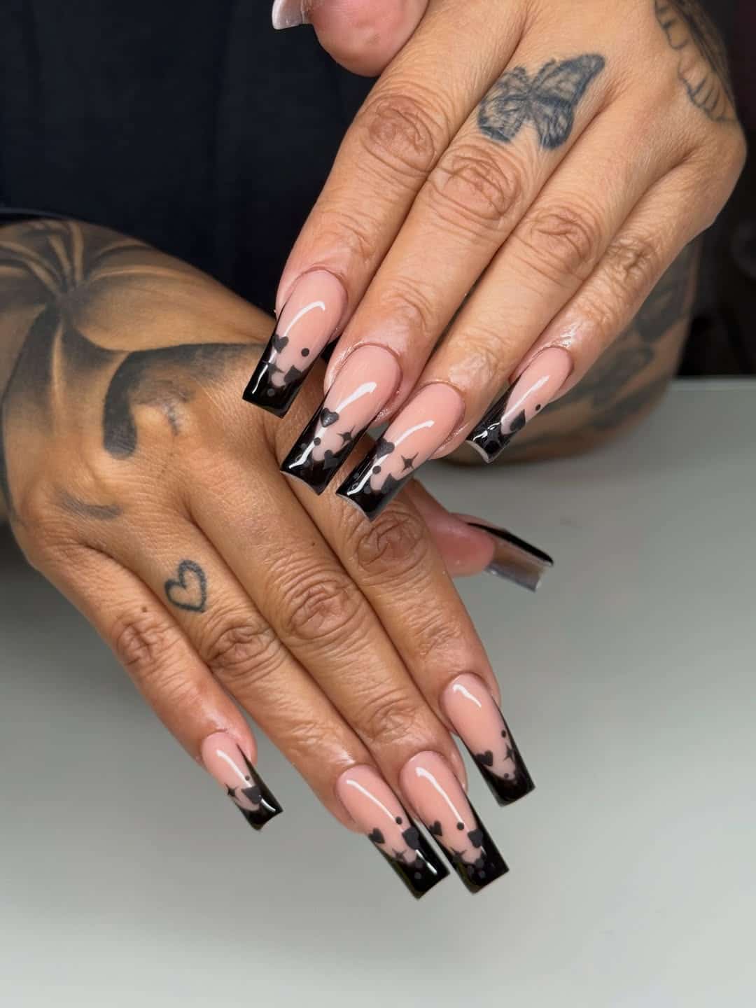 14. Black French Tip Coffin Nails with Heart and Sparkle Art - black coffin nail ideas