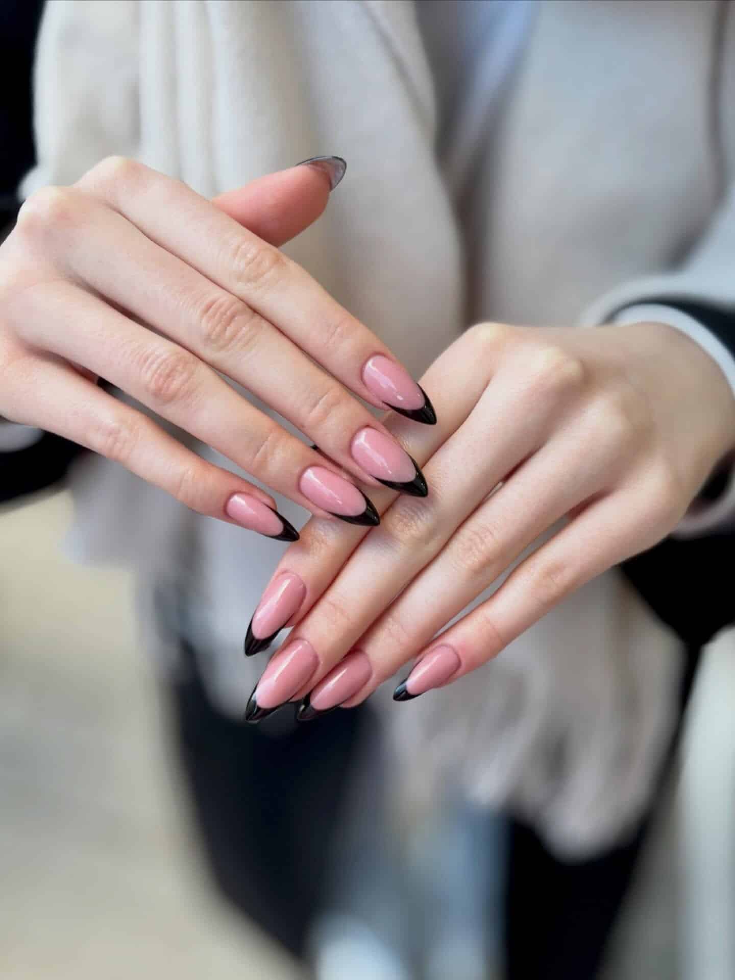 1. Glossy Black French Tips on Pink Almond Nails - black french nail ideas