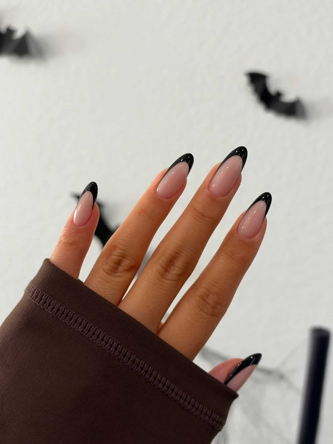 2. Classic Black French Almond Nails with Nude Pink Base - black french nail ideas