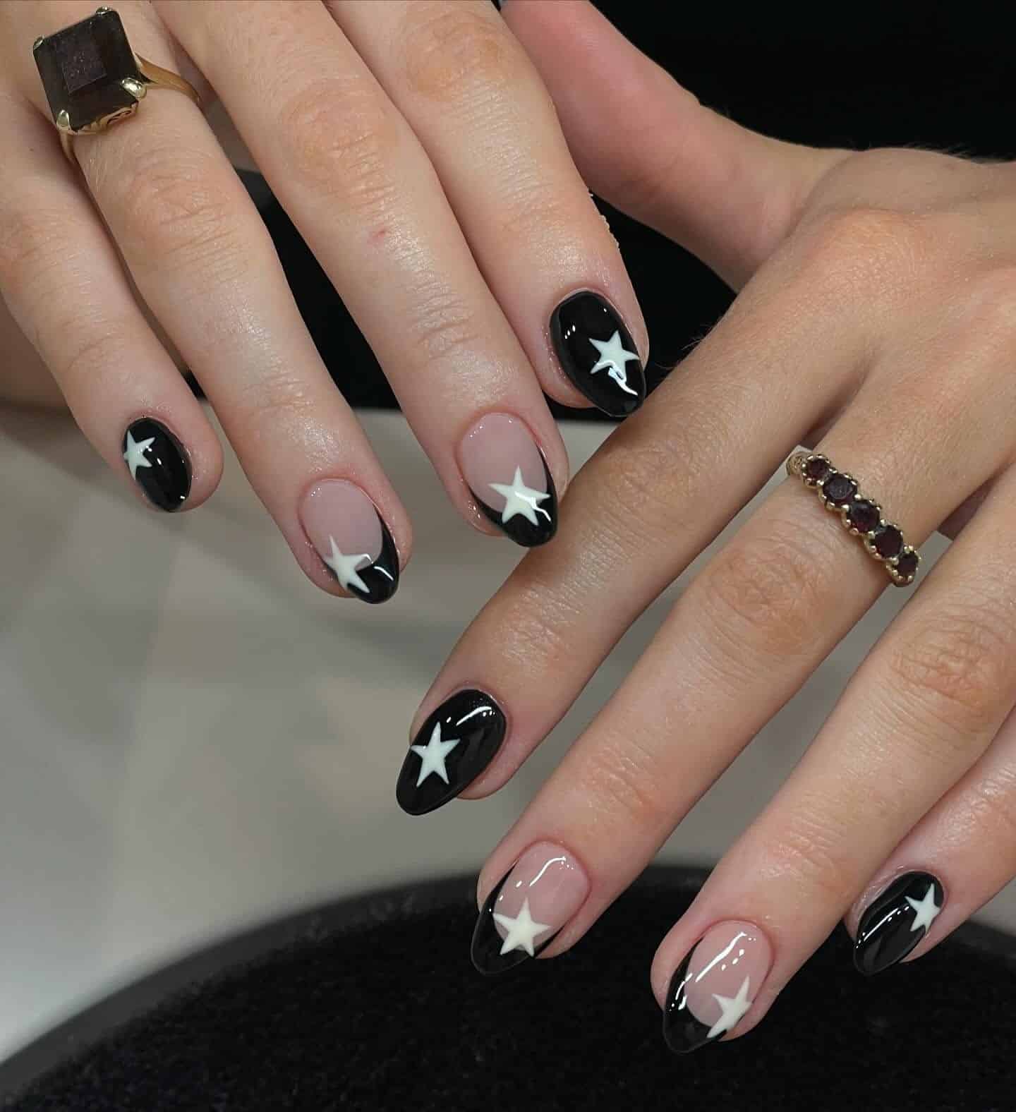 4. Black French Tip Nails with White Star Accents - black french nail ideas