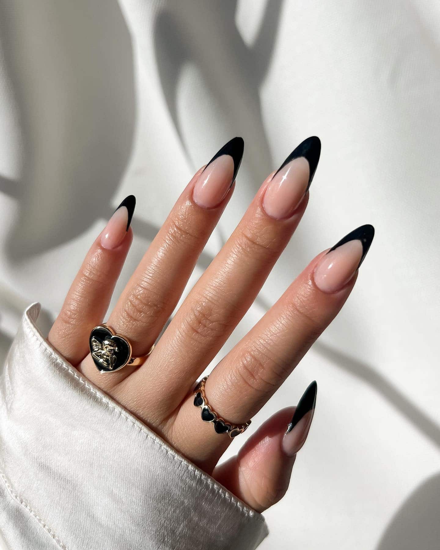 7. Minimalist Black French Tips on Long Almond Nails - black french nail ideas
