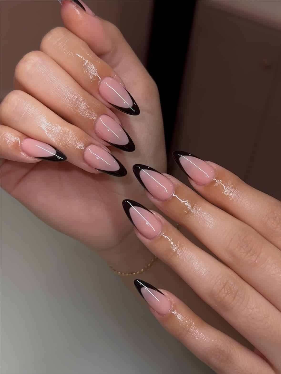 22. Glossy Black French Stiletto Nails with Soft Pink Base - black french nail ideas