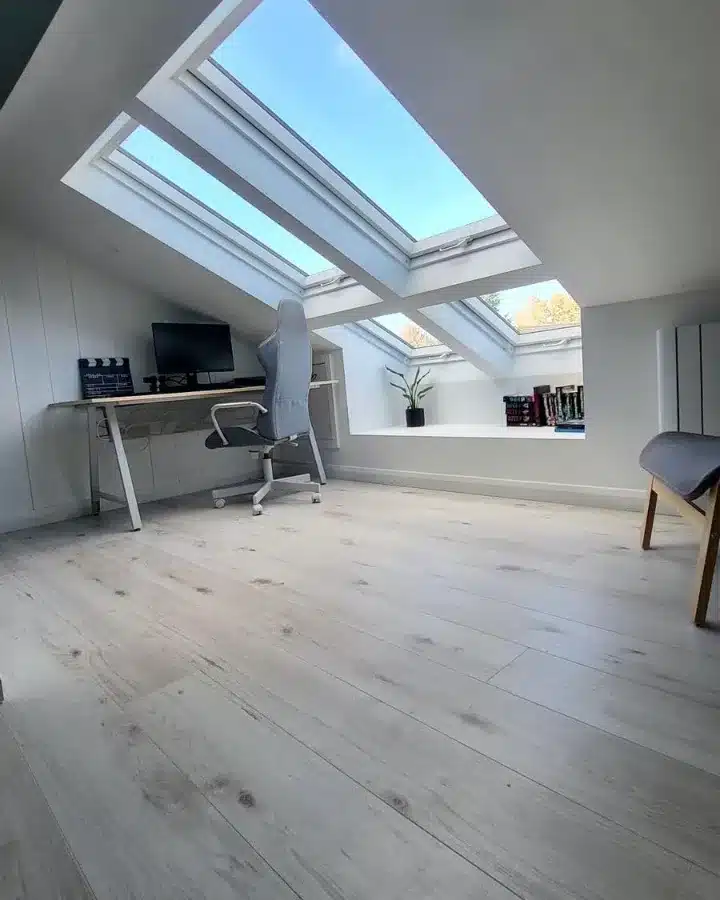3. Minimalist White and Light Gray Attic Office with Skylights - attic office ideas