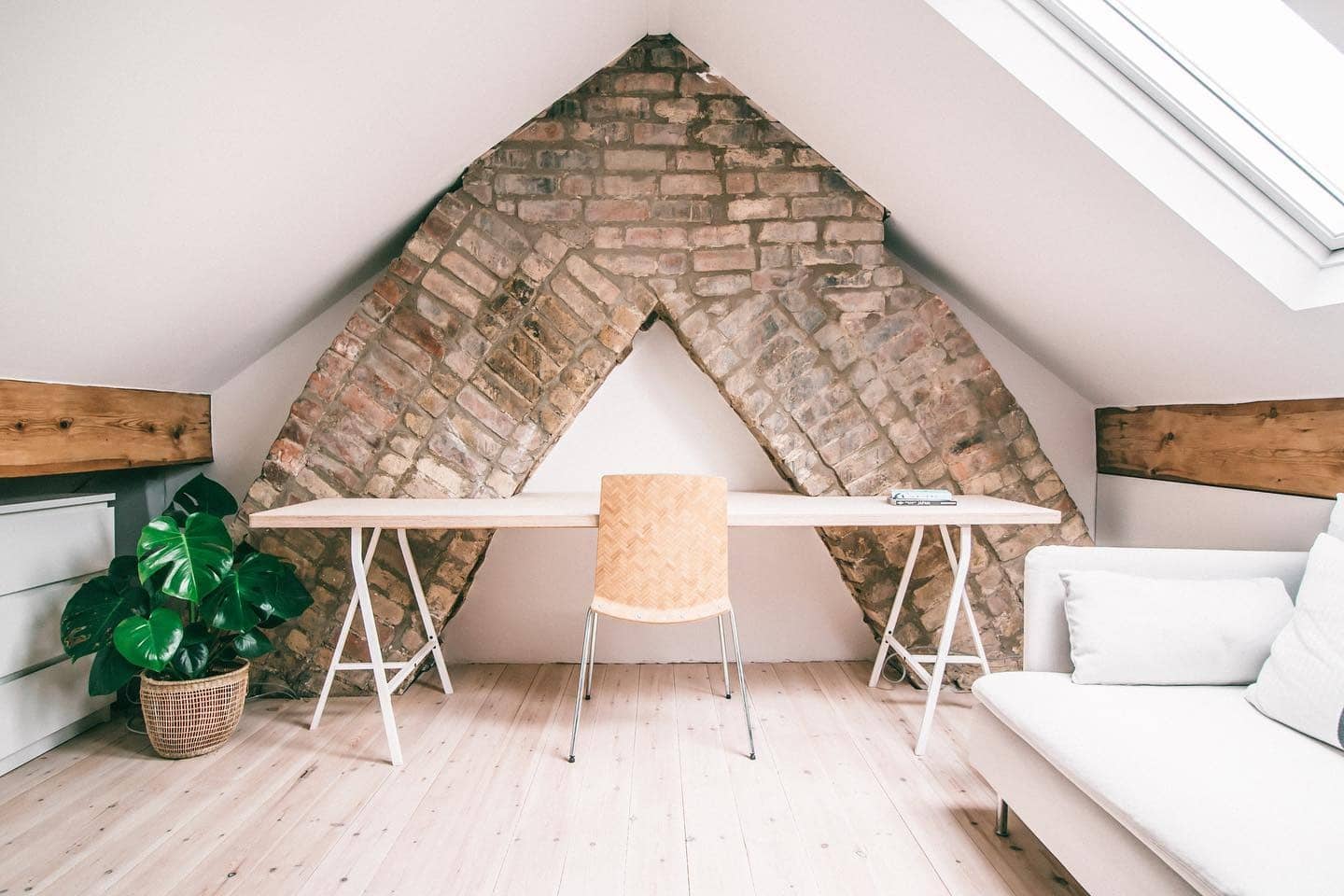 7. Rustic White and Exposed Brick Attic Office with Natural Wood Details - attic office ideas