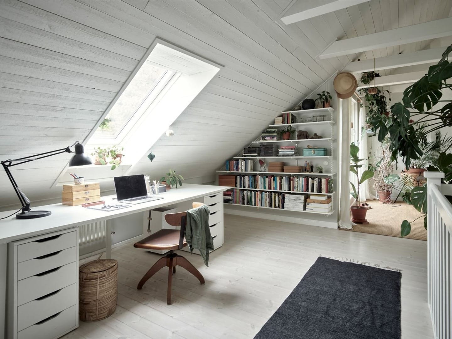 16. Scandinavian White and Charcoal Attic Office with Botanical Decor - attic office ideas