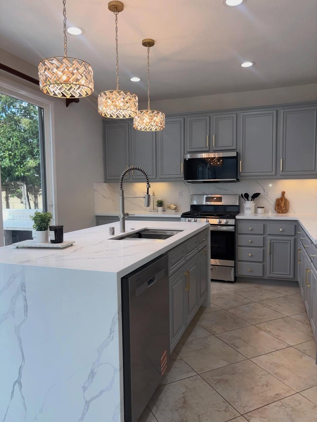 9. Chic Medium Grey Kitchen with Gold Pendant Lighting - grey cabinet kitchen ideas