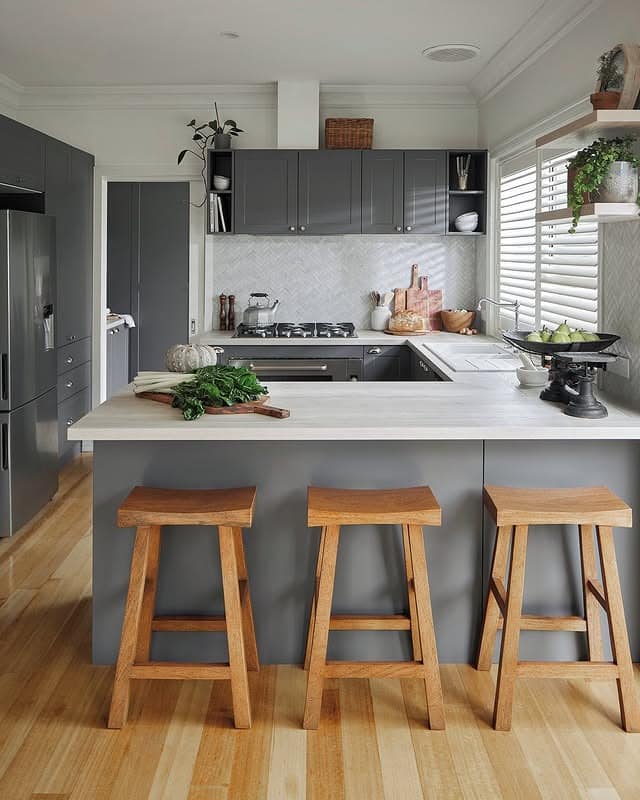 10. Minimalist Dark Grey Kitchen with Light Wood Breakfast Bar - grey cabinet kitchen ideas
