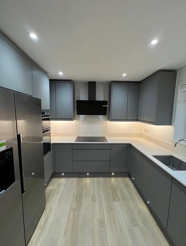 11. Sleek Steel Grey Kitchen Cabinets with Modern Lighting - grey cabinet kitchen ideas