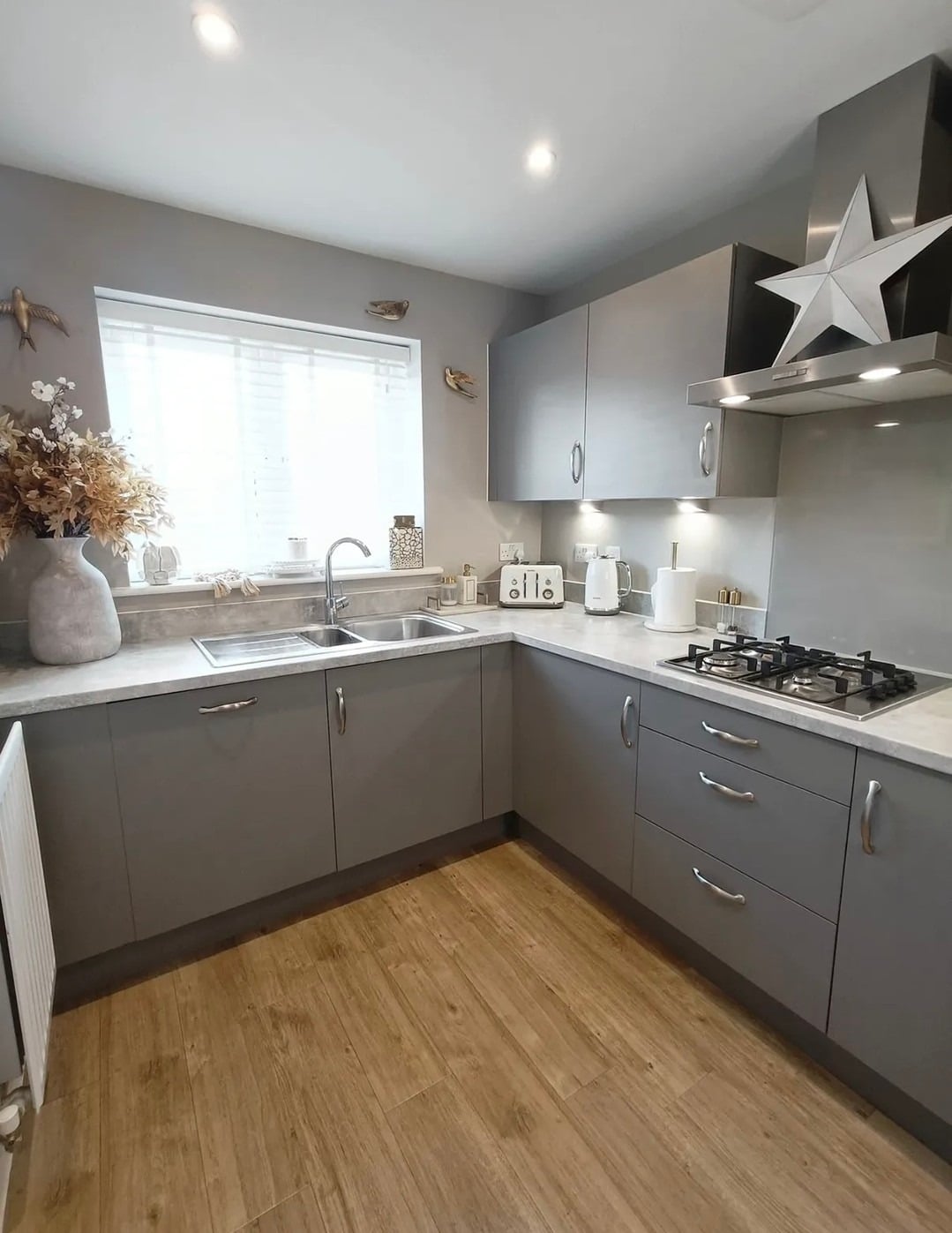 13. Cozy Medium Grey Kitchen Cabinets with Natural Wood Flooring - grey cabinet kitchen ideas